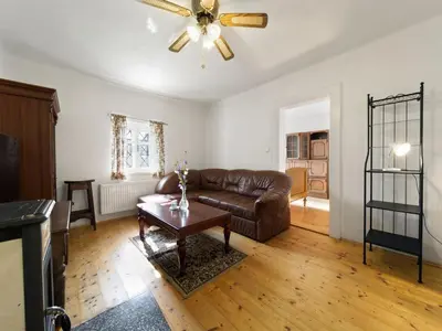 a living room with a couch and a table at Holiday Home Praskolesy by Interhome in Praskolesy
