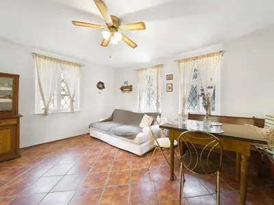 a living room with a couch and a ceiling fan at Holiday Home Praskolesy by Interhome in Praskolesy