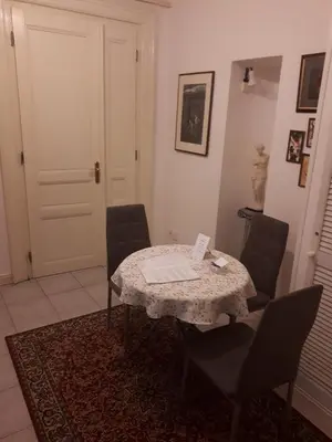 a room with a table with chairs and a door at Apartment Josef in Prague