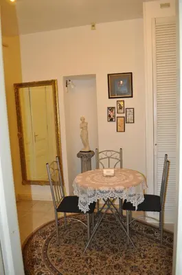 a dining room with a table and chairs and a mirror at Apartment Josef in Prague