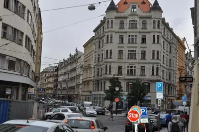 a busy city street with cars parked in front of buildings at Apartment Josef in Prague