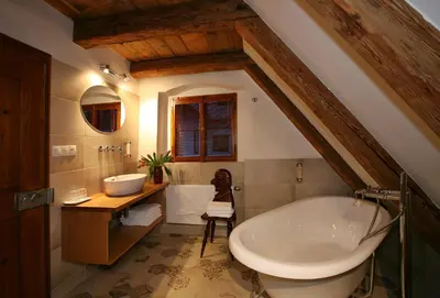 a bathroom with a large tub and a sink at Residence U Mecenáše in Prague