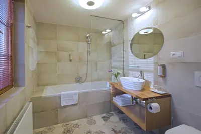 a bathroom with a tub and a sink and a bath tubermott at Residence U Mecenáše in Prague