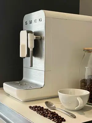 a coffee machine sitting on a counter with coffee beans at Luxury Penthouse Apartment in Prague