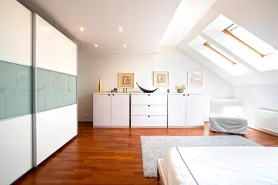 a bedroom with white cabinets and a bed at Luxury Penthouse Apartment in Prague