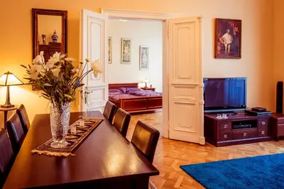 a living room with a dining table and a television at Apartment Vodičkova 11 in Prague