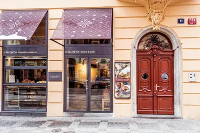 a facade of a store with a brown door at Apartment Vodičkova 11 in Prague