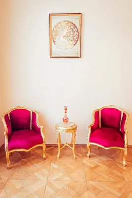 two chairs and a table with a picture on the wall at Apartment Vodičkova 11 in Prague