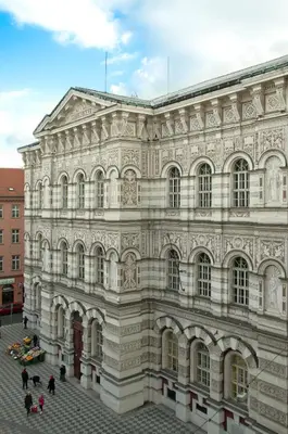 a large building with people standing outside of it at Apartment Vodičkova 11 in Prague
