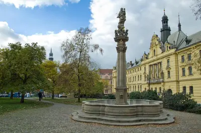 a statue in a park in front of a building at Apartment Vodičkova 11 in Prague