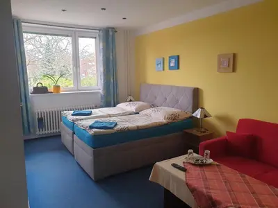 a bedroom with a bed and a window at Pension Beránek in Prague