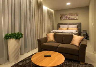 a living room with a couch and a bed at MG Restaurace/Luxury Apartments in Mladá Boleslav