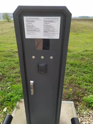 a ticket machine in a park with a field in the background at MG Restaurace/Luxury Apartments in Mladá Boleslav