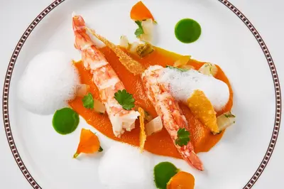 a plate of food with fish and oranges on it at MG Restaurace/Luxury Apartments in Mladá Boleslav