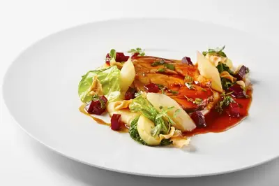 a plate of food with a salad on a white plate at MG Restaurace/Luxury Apartments in Mladá Boleslav