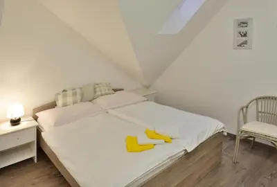 a bedroom with a bed with yellow shoes on it at Pension 101 Dubá in Dubá