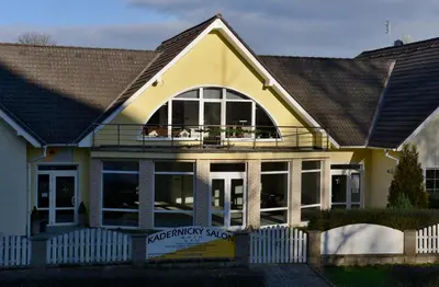 a yellow house with a white fence in front of it at Pension 101 Dubá in Dubá