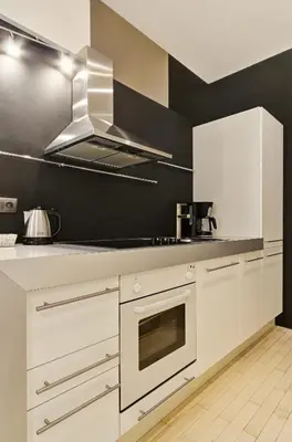 a kitchen with white cabinets and a stove top oven at Historic Centre Apartments VI in Prague