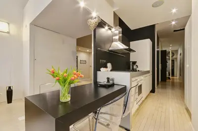a kitchen with a vase of flowers on a counter at Historic Centre Apartments VI in Prague
