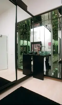 a large mirror reflecting a room with a desk in it at Historic Centre Apartments VI in Prague