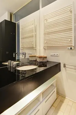 a bathroom with a black counter and a sink at Historic Centre Apartments VI in Prague