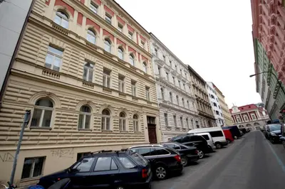 a building with cars parked on the side of a street at Hálkova Studio in Prague
