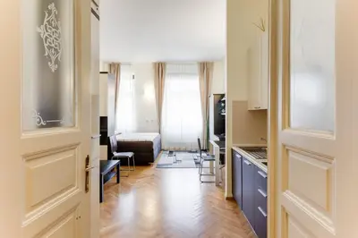 a hallway with a door leading to a living room at Hálkova Studio in Prague
