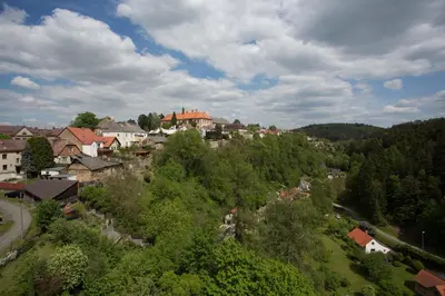 a village on a hill with houses and trees at Penzion Ctrnactka in Rataje nad Sázavou