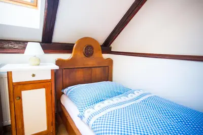 a bedroom with a bed and a table with a lamp at Penzion Ctrnactka in Rataje nad Sázavou