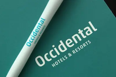 a white toothbrush sitting on top of a green book at Occidental Praha Wilson in Prague