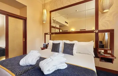 a hotel room with two towels on a bed at Occidental Praha Wilson in Prague