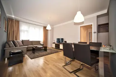 a living room with a table and a dining room at Art Residence Krocinova in Prague