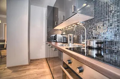 a kitchen with a counter with two sinks in it at Art Residence Krocinova in Prague
