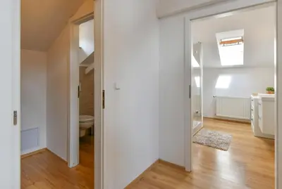 a hallway with a door leading to a bathroom at Apartments Rybná in Prague