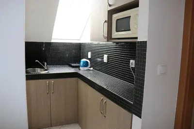 a kitchen with a sink and a microwave at Penzion Kotvas in Milovice