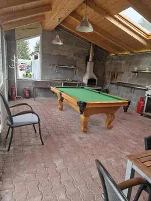 a pool table in the middle of a patio at Penzion Kotvas in Milovice