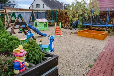 a childrens playground with swings and play equipment at Penzion Kotvas in Milovice