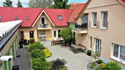 an overhead view of a courtyard of a building with benches at Penzion Kotvas in Milovice