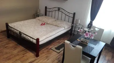 a bedroom with a bed and a desk and a table with a table at Apartment Jakubská 676 in Prague