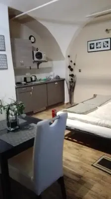 a bedroom with a bed and a table and a chair at Apartment Jakubská 676 in Prague