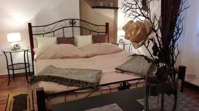 a bedroom with a large bed with a metal frame at Apartment Jakubská 676 in Prague