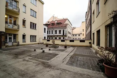 an empty courtyard in a city with buildings at Champagne Studio with Sauna in Prague
