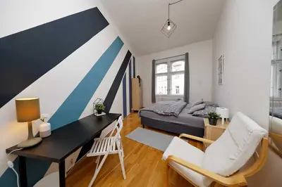 a bedroom with a desk and a bed in a room at Apartment Na Kozacce 6 in Prague