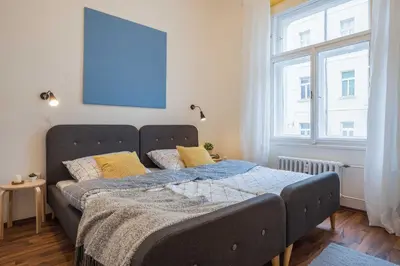 a bed in a room with a large window at Apartment Na Kozacce 6 in Prague