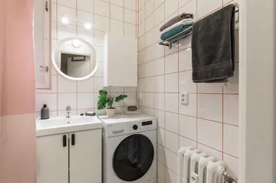 a bathroom with a washing machine and a sink at Apartment Na Kozacce 6 in Prague