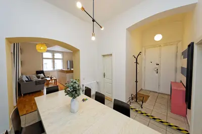 a dining room and living room with a table and chairs at Apartment Na Kozacce 6 in Prague
