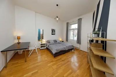 a bedroom with a bed and a desk at Apartment Na Kozacce 6 in Prague