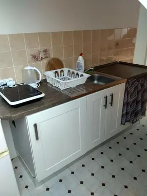 a kitchen with a sink and a counter top at Guest House Kaskáda in Vrané nad Vltavou
