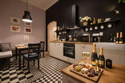 a kitchen with a table with wine glasses and a dining room at Wishlist Old Prague Residences - New Town in Prague