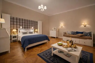 a bedroom with a bed and a couch and a table at Wishlist Old Prague Residences - New Town in Prague